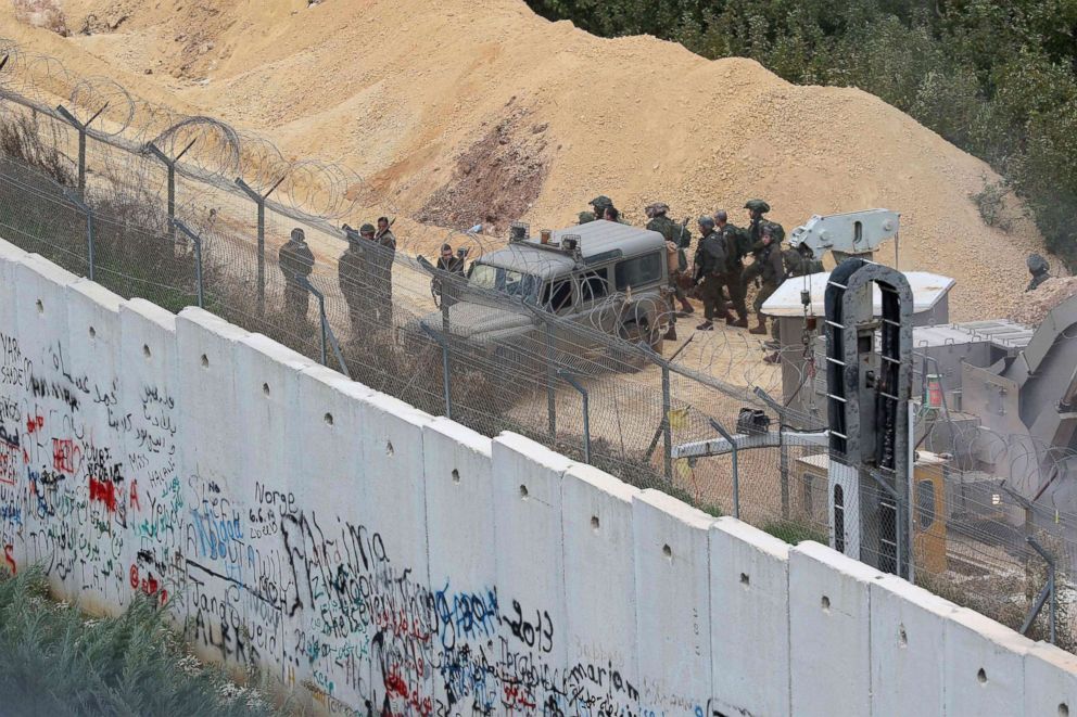 PHOTO: Israeli soldiers gather by an army vehicle at the Lebanon-Israel border wall near the site of an Israeli excavation site for reported cross-border Hezbollah-dug tunnels, Dec. 5, 2018.