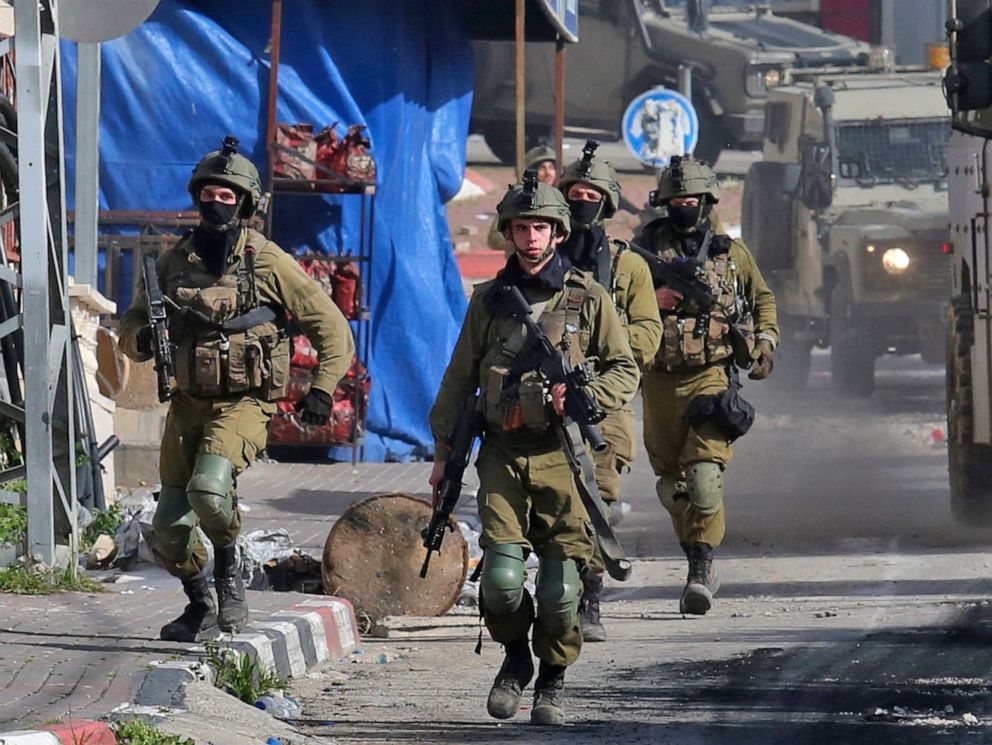 PHOTO: Israeli soldiers patrol on March 30, 2022 in a village south of Jenin in the occupied West Bank, reportedly from where Palestinian assailant Diaa Hamarshah left before killing five people during a gun attack in Israel.