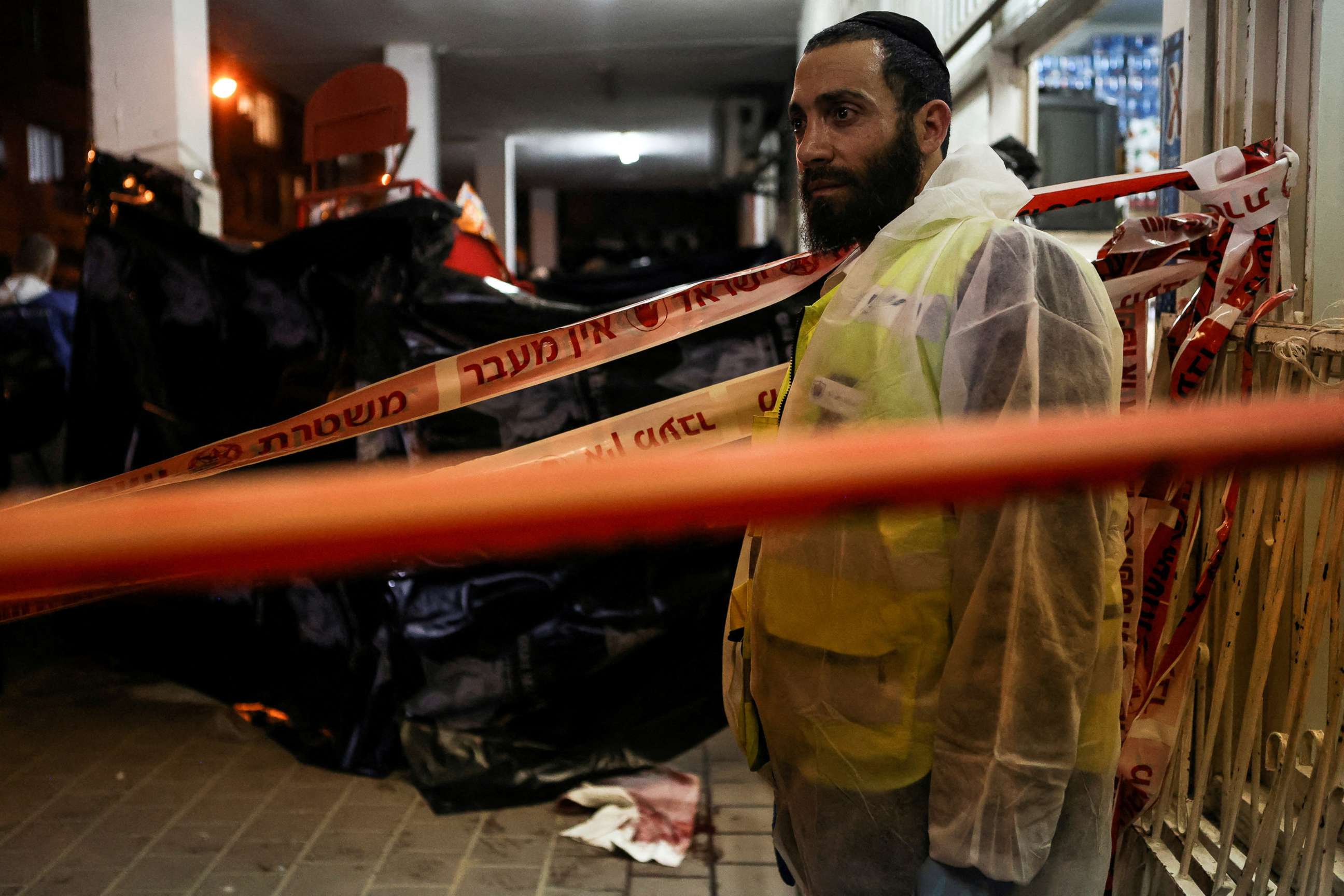 PHOTO: A police forensic expert pauses as he works at the scene of a fatal mass shooting attack on a street in Bnei Brak, near Tel Aviv, Israel, March 29, 2022.