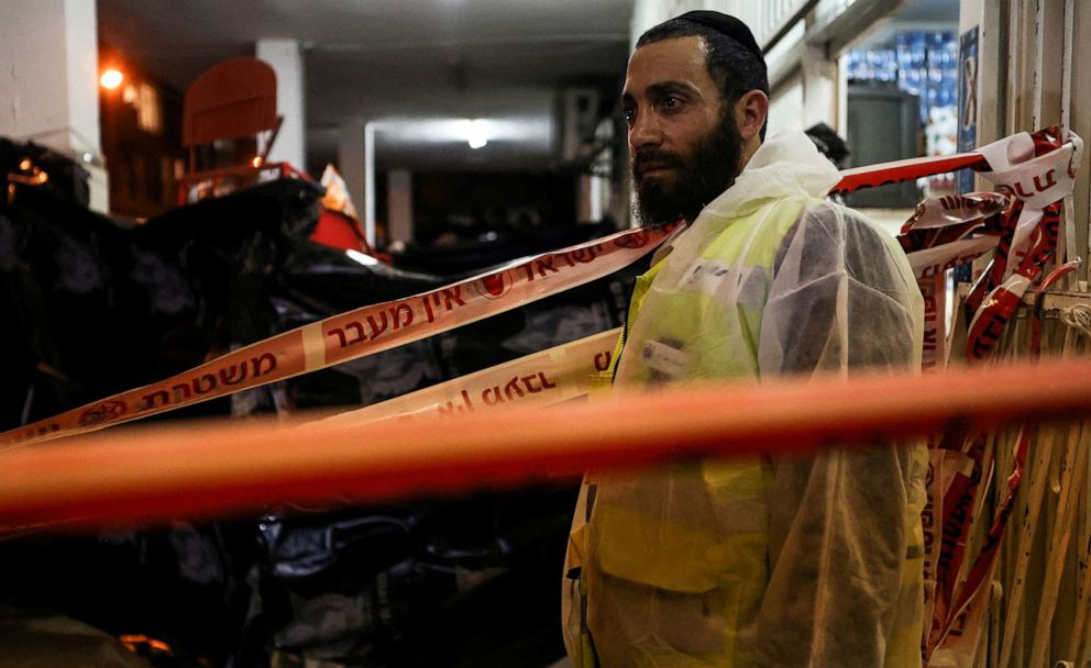 PHOTO: A police forensic expert pauses as he works at the scene of a fatal mass shooting attack on a street in Bnei Brak, near Tel Aviv, Israel, March 29, 2022.
