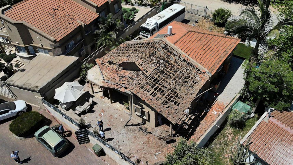 PHOTO: Israelis inspect the damage to their house following a rocket attack from the Gaza Strip, in the southern Israeli city of Sderot on May 15, 2021.