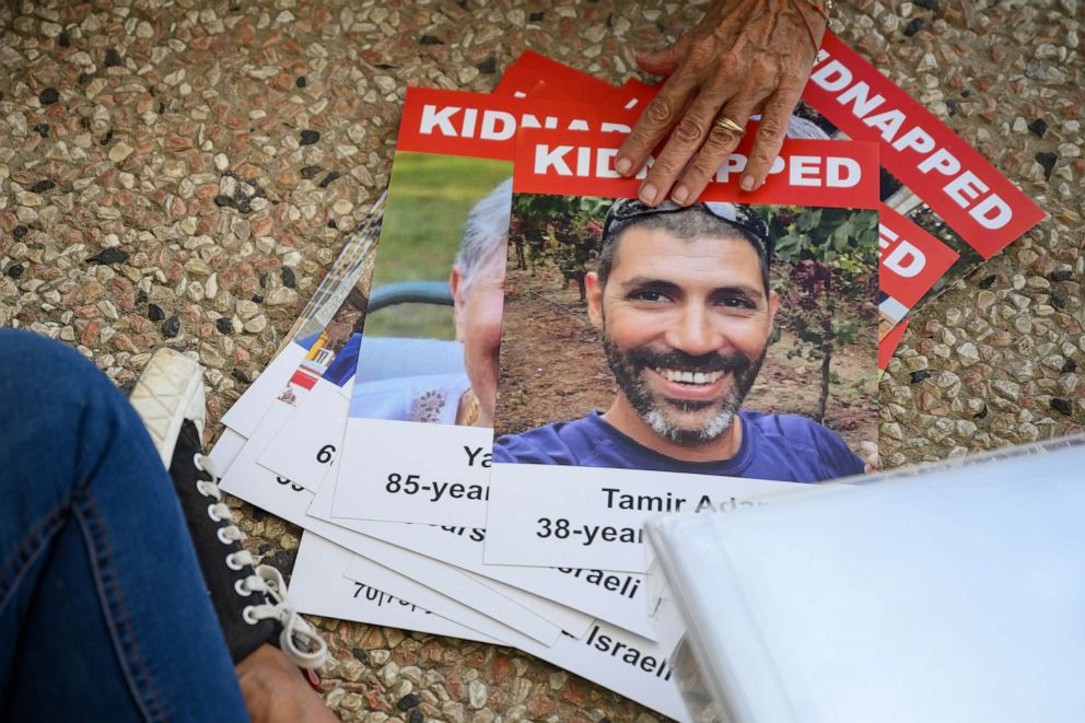 PHOTO: Photographs of the missing are seen as a "Shabbat Dinner" table is prepared at the Tel Aviv museum plaza, with 200 empty seats, representing the hostages and missing people on Oct. 20, 2023 in Tel Aviv Israel.