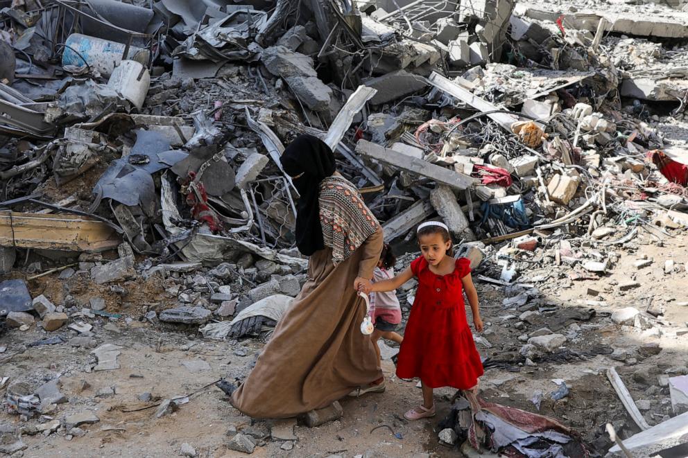 PHOTO: A woman and child walk among debris, aftermath of Israeli strikes at the area, where Israeli hostages were rescued on Saturday, as Palestinian death toll rises to 274, June 9, 2024.