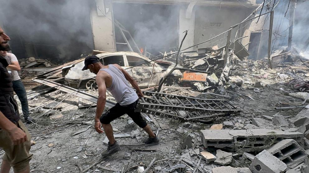 PHOTO: A Palestinian man retrieves a ladder used in an operation by Israeli Special Forces in the Nuseirat camp, in the central Gaza Strip, on June 8, 2024. 