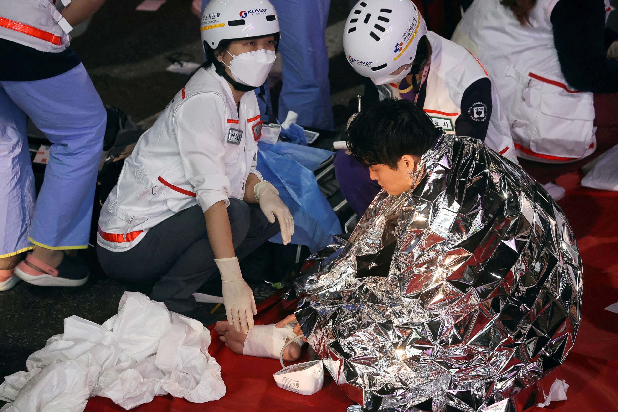 PHOTO: A man receives medical help from rescue team members at the scene of a stampede during a Halloween festival in Seoul, South Korea, Oct. 30, 2022.