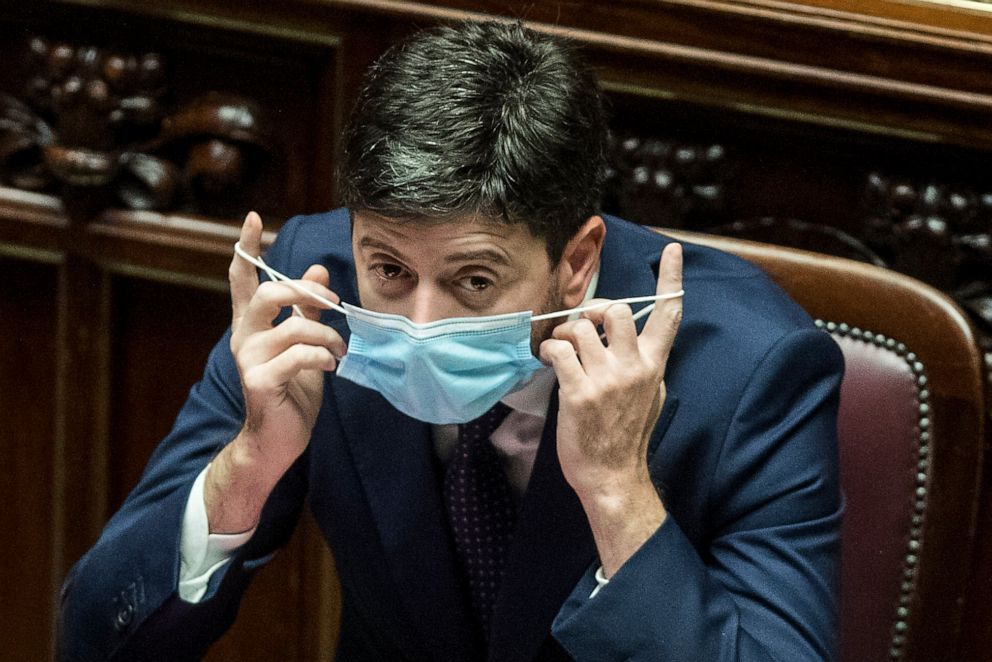 PHOTO: Italian Health Minister Roberto Speranza removes his face mask prior to the start of his address at the lower house of parliament in Rome on Oct. 6, 2020.