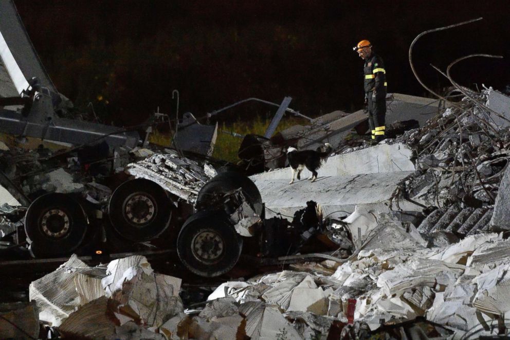 PHOTO: Rescue teams search for survivors among the rubble of the collapsed Morando highway bridge in Genoa, northern Italy, on Aug. 14, 2018.