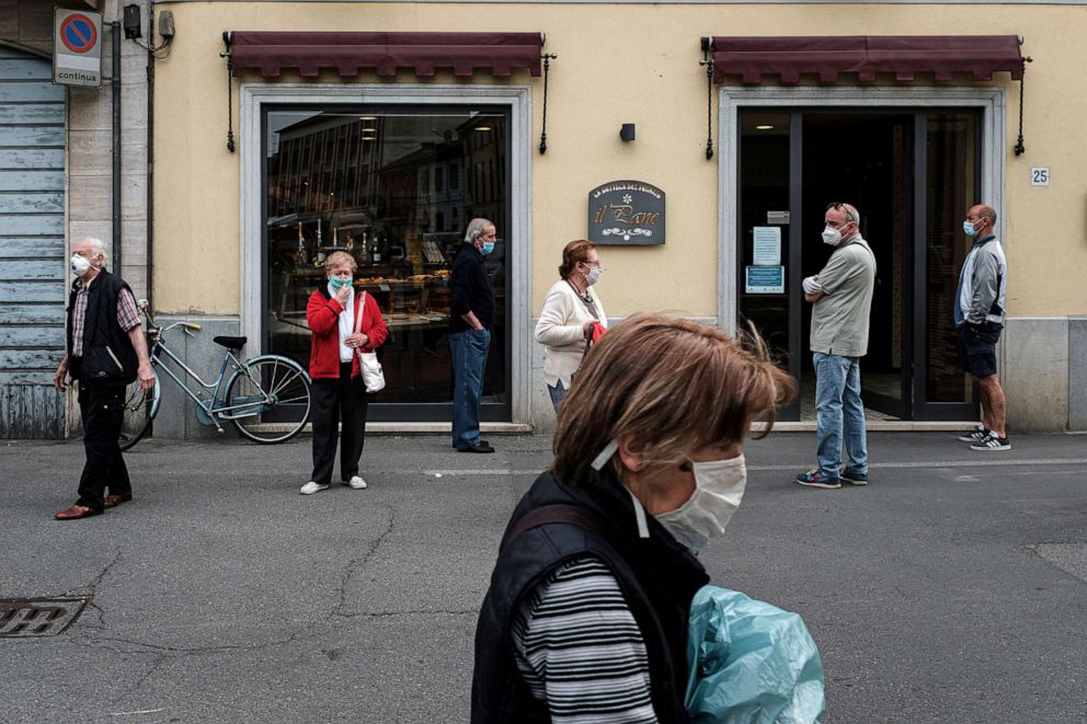 PHOTO: People queue using social distancing outside a patisserie in Codogno, the small northern town where Italy's first patient was diagnosed with the coronavirus disease, as the country begins a staged end to a nationwide lockdown, May 5, 2020.