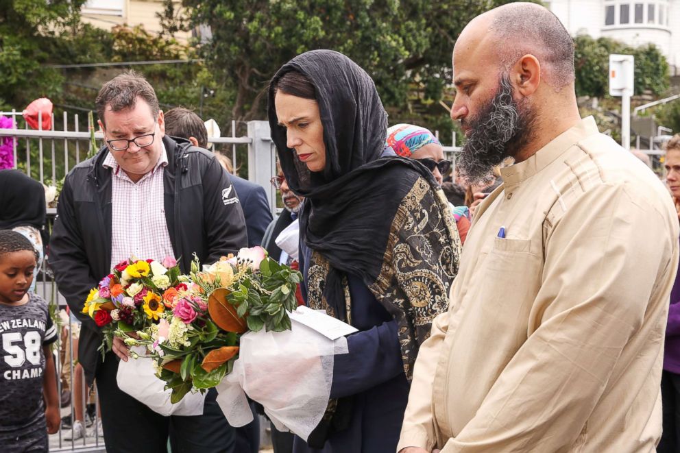 PHOTO: Prime Minister Jacinda Ardern lays flowers for victims of a mass shooting attack while finance minister Grant Robertson looks on at the Kilbirnie Mosque on March 17, 2019 in Wellington, New Zealand.