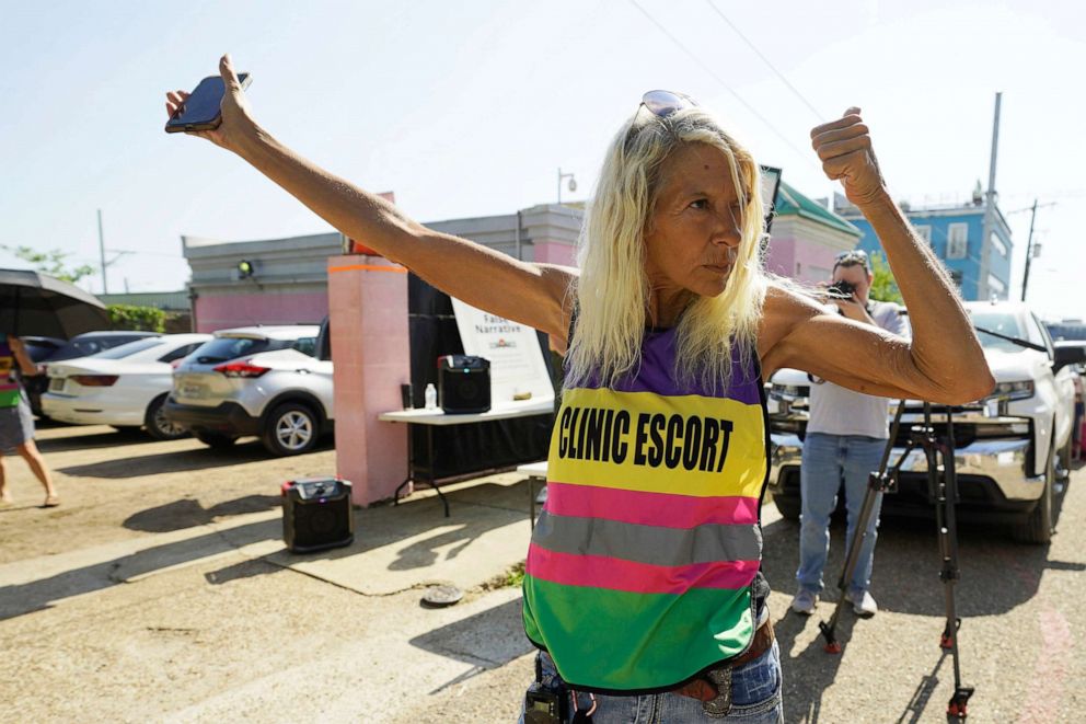 Pink House defender Derenda Hancock gestures at anti-abortion opponents protesting outside the Jackson Women's Health Organization clinic in Jackson, Miss. moments before the U.S. Supreme Court ruling overturning Roe v. Wade was issued, June 24, 2022.