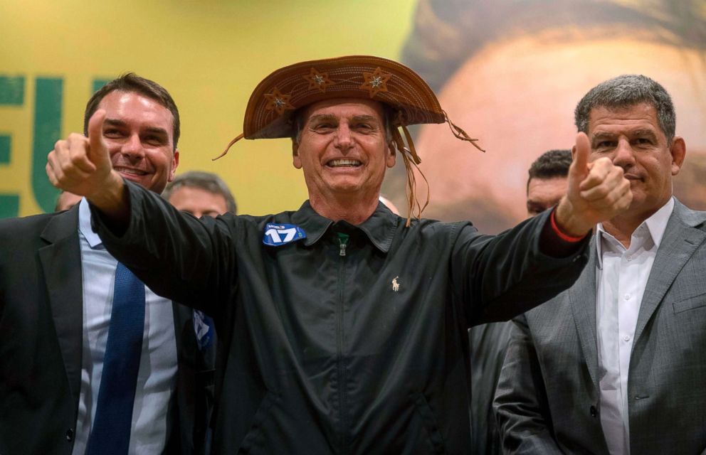 PHOTO: Brazil's right-wing presidential candidate for the Social Liberal Party, Jair Bolsonaro, center, gestures during a press conference in Rio de Janeiro, Oct. 11, 2018.