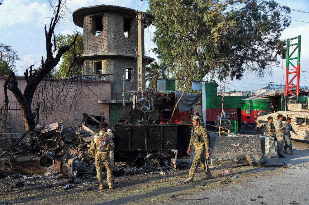 PHOTO: In this picture taken on Aug. 3, 2020, Afghan soldiers walk past debris near the main entrance of a prison after a raid in Jalalabad, Afghanistan.