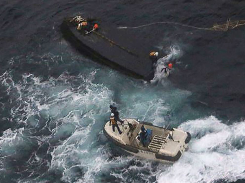 PHOTO: A Japan Coast Guard rescue team approaches a capsized North Korean boat (top) on the Sea of Japan (East Sea), about 225 miles northwest of the Noto Peninsula in Ishikawa Prefecture, Nov. 15, 2017.