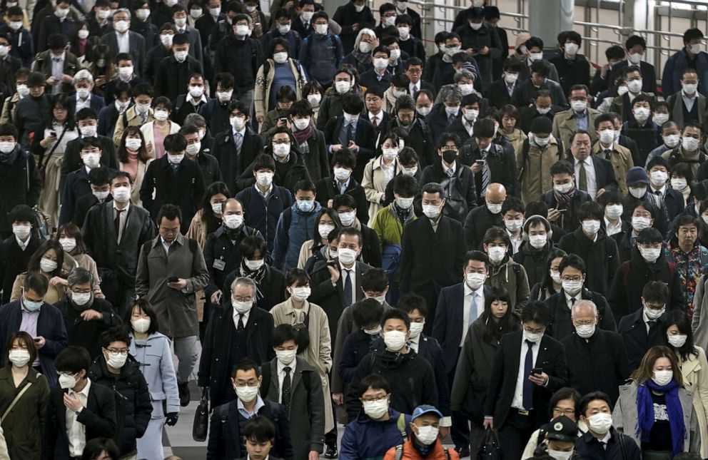 PHOTO: Commuters wear masks at a station in Tokyo, Japan, March 31, 2020, during the coronavirus pandemic.