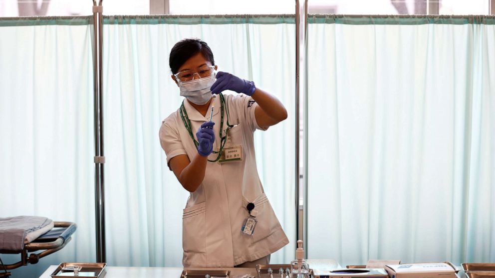PHOTO: A medical worker fills a syringe with a dose of the Pfizer-BioNTech coronavirus vaccine as Japan launches its inoculation campaign, at Tokyo Medical Center in Tokyo, Feb. 17, 2021.