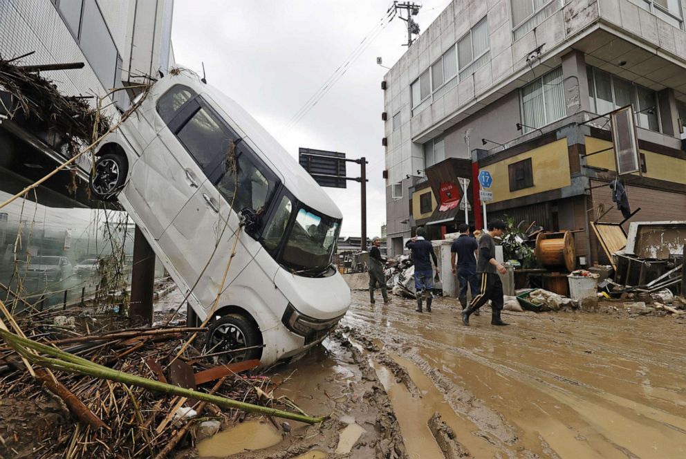 PHOTO: A car is left upended on a street in the flood-ravaged city of Hitoyoshi in Kumamoto Prefecture, southwestern Japan, on July 7, 2020.