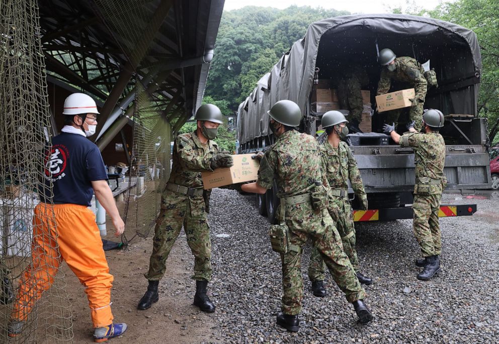 PHOTO: Members of Japan Self-Defense Forces unload relief supplies in the flood hit village of Kumamura, Kumamoto prefecture on July 9, 2020.