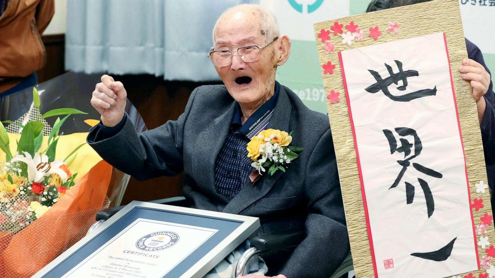 PHOTO: Chitetsu Watanabe, 112, poses next to the calligraphy he wrote after being awarded as the world's oldest living male by Guinness World Records, in Joetsu, Niigata prefecture, northern Japan Feb. 12, 2020.