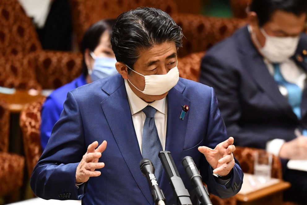 PHOTO: Japanese Prime Minister Shinzo Abe wears a face mask while answering questions during an upper house budget committee session at the parliament in Tokyo on April 30, 2020.