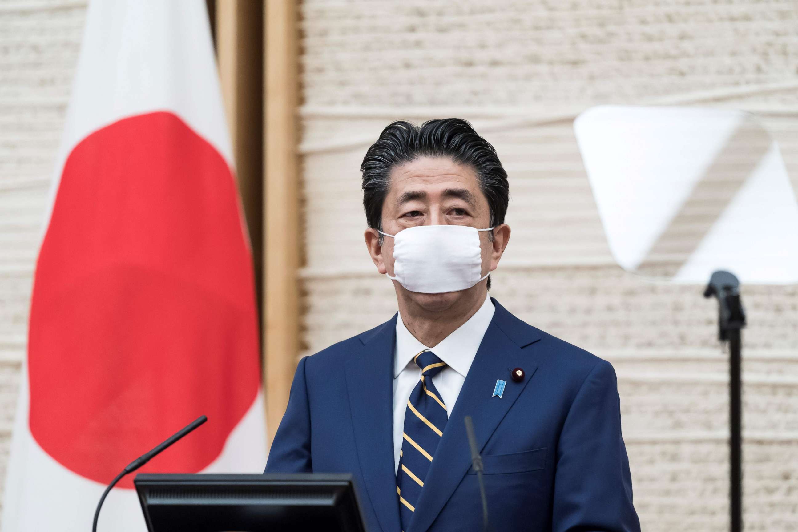 PHOTO: Japanese Prime Minister Shinzo Abe wearing a face mask attends a press conference at his official residence in Tokyo on April 7, 2020. 