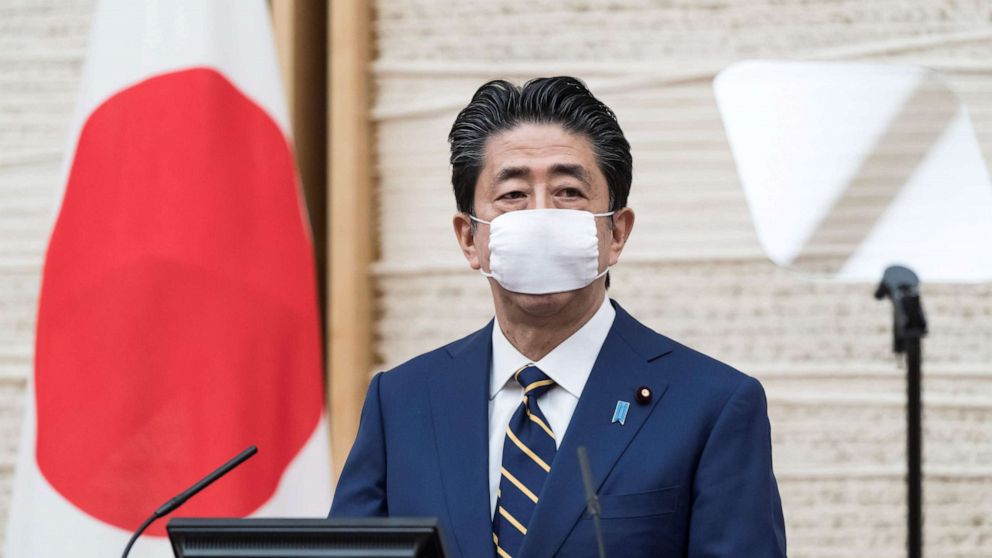 PHOTO: Japanese Prime Minister Shinzo Abe wearing a face mask attends a press conference at his official residence in Tokyo on April 7, 2020. 