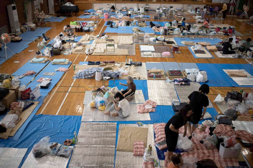 PHOTO: People affected by the recent flooding rest at a makeshift shelter in Mabi, Okayama prefecture, Japan, July 11, 2018.