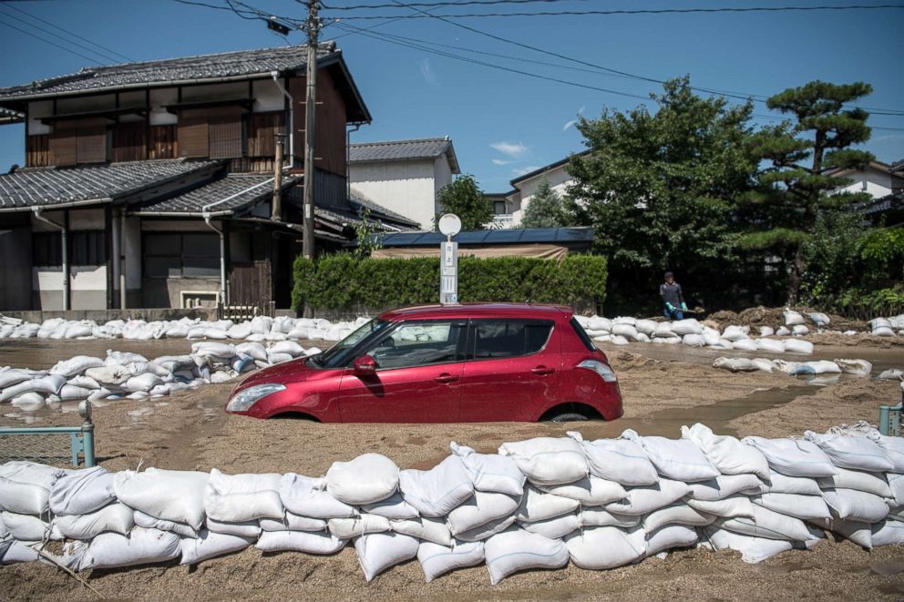 PHOTO: A car sits submerged in mud following a landslide, July 10, 2018, in Yanohigashi near Hiroshima, Japan.
