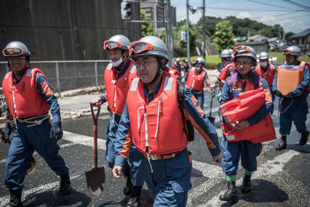 PHOTO: Emergency service workers arrive to search for people following a landslide, July 10, 2018, in Yanohigashi near Hiroshima, Japan.