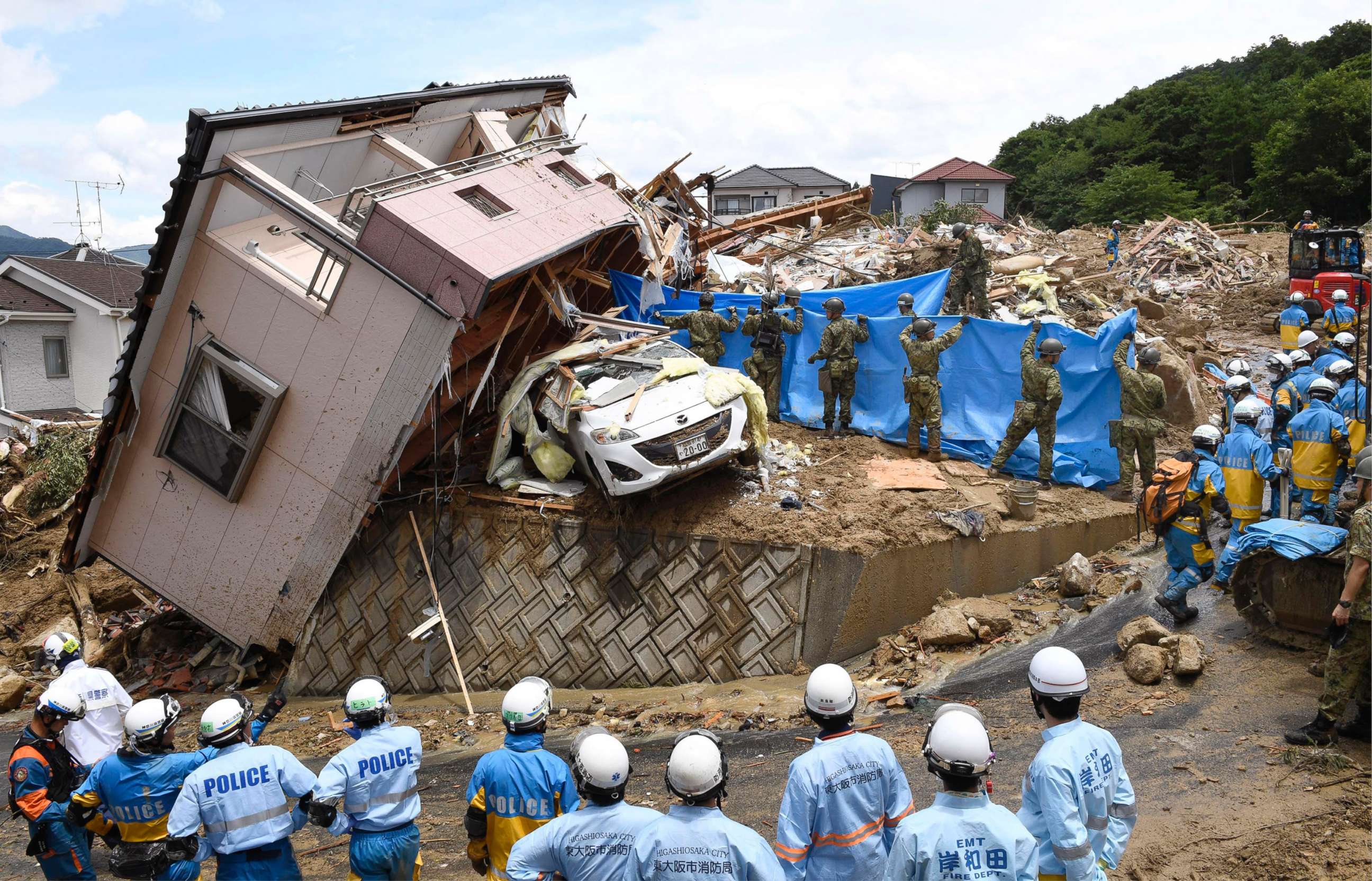 PHOTO: Rescuers conduct a search operation for missing persons in Kumano town, Hiroshima prefecture, western Japan Monday, July 9, 2018.