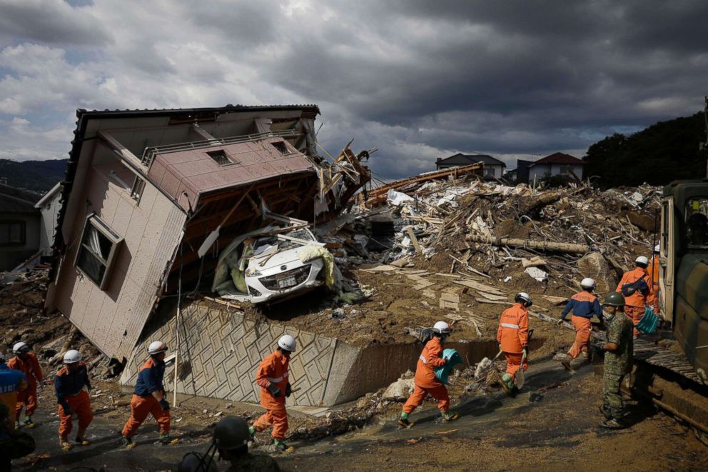 PHOTO: Rescuers conduct a search operation for missing persons in Kumano town, Hiroshima prefecture, western Japan, July 9, 2018.