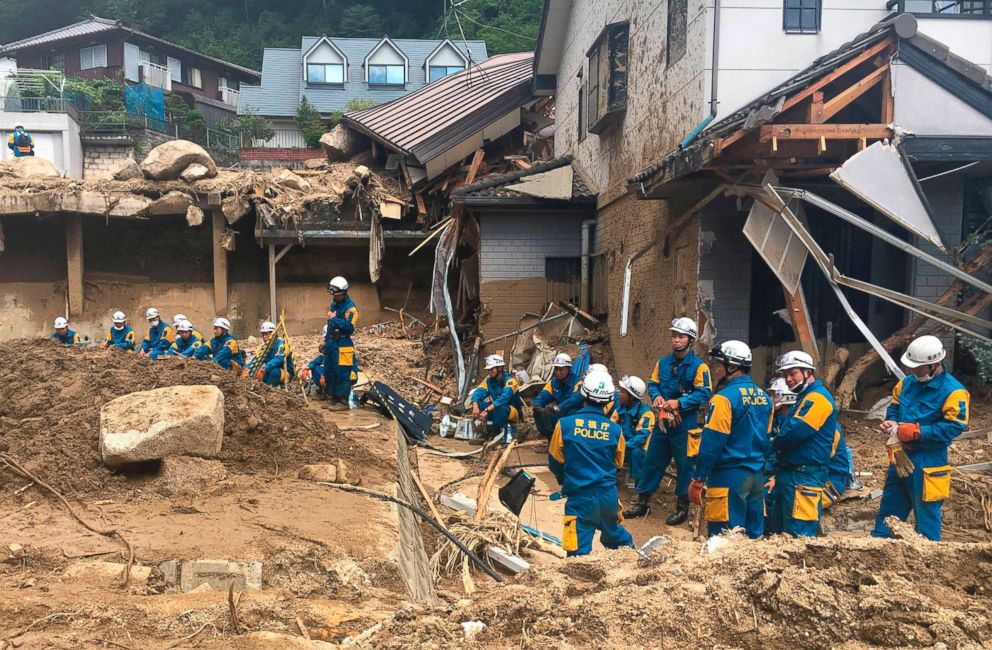 PHOTO: Emergency teams rest outside of structural damage caused by heavy rains, July 9, 2018, in Hiroshima, Japan.