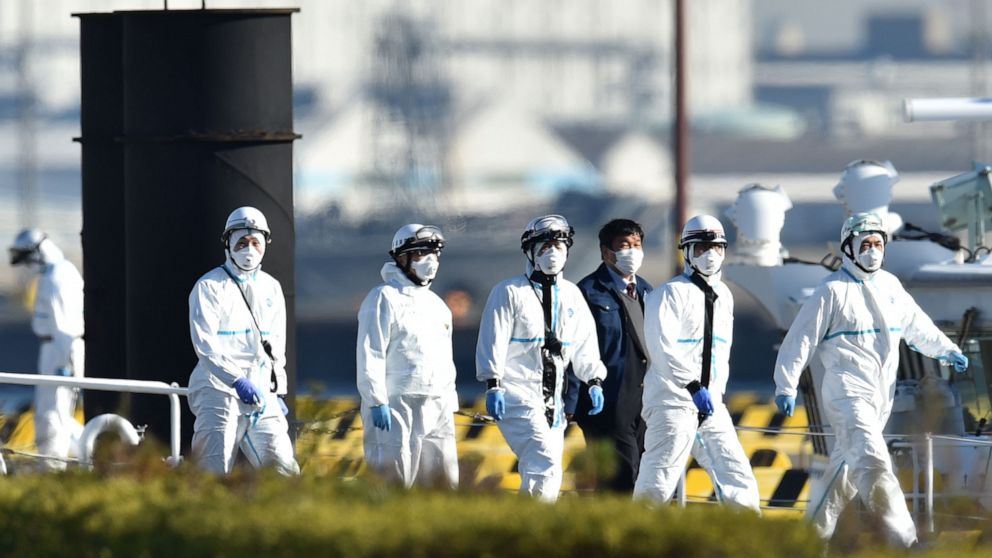 PHOTO: Personnel clad in protective gear, tasked to provide care for suspected coronavirus patients on board the Diamond Princess cruise ship, are seen at the Japan Coast Guard base in Yokohama on Feb. 5, 2020.