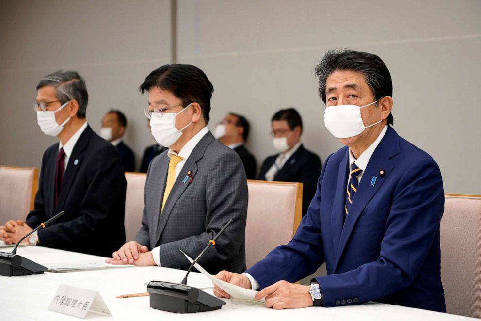 PHOTO: Japanese Prime Minister Shinzo Abe, right, declares a state of emergency for seven prefectures during a meeting of the task force against the novel coronavirus outbreak at the his official residence in Tokyo, April 7, 2020.