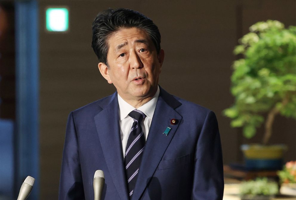 PHOTO: Japanese Prime Minister Shinzo Abe speaks to reporters at his office in Tokyo on May 21, 2020. Abe lifted a state of emergency in several big cities in western Japan and hinted that the measure would be removed nationwide as early as next week.