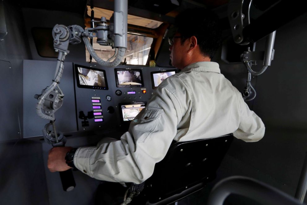 PHOTO: Sakakibara Kikai's engineer Masaaki Nagumo controls the bipedal robot Mononofu from its cockpit during its demonstration at its factory in Shinto Village, Gunma Prefecture, Japan, April 12, 2018.