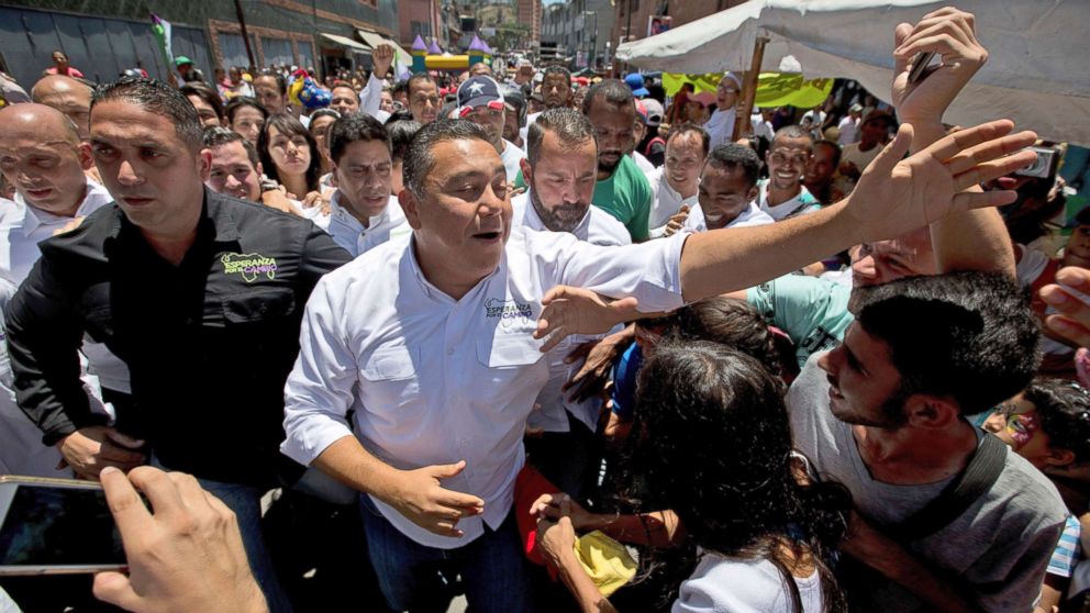 Venezuelan presidential candidate Javier Bertucci, center, greets supporters during a rally in Caracas, Venezuela, May 12, 2018. Venezuelans will vote for a new president in the upcoming presidential elections on May 20.
