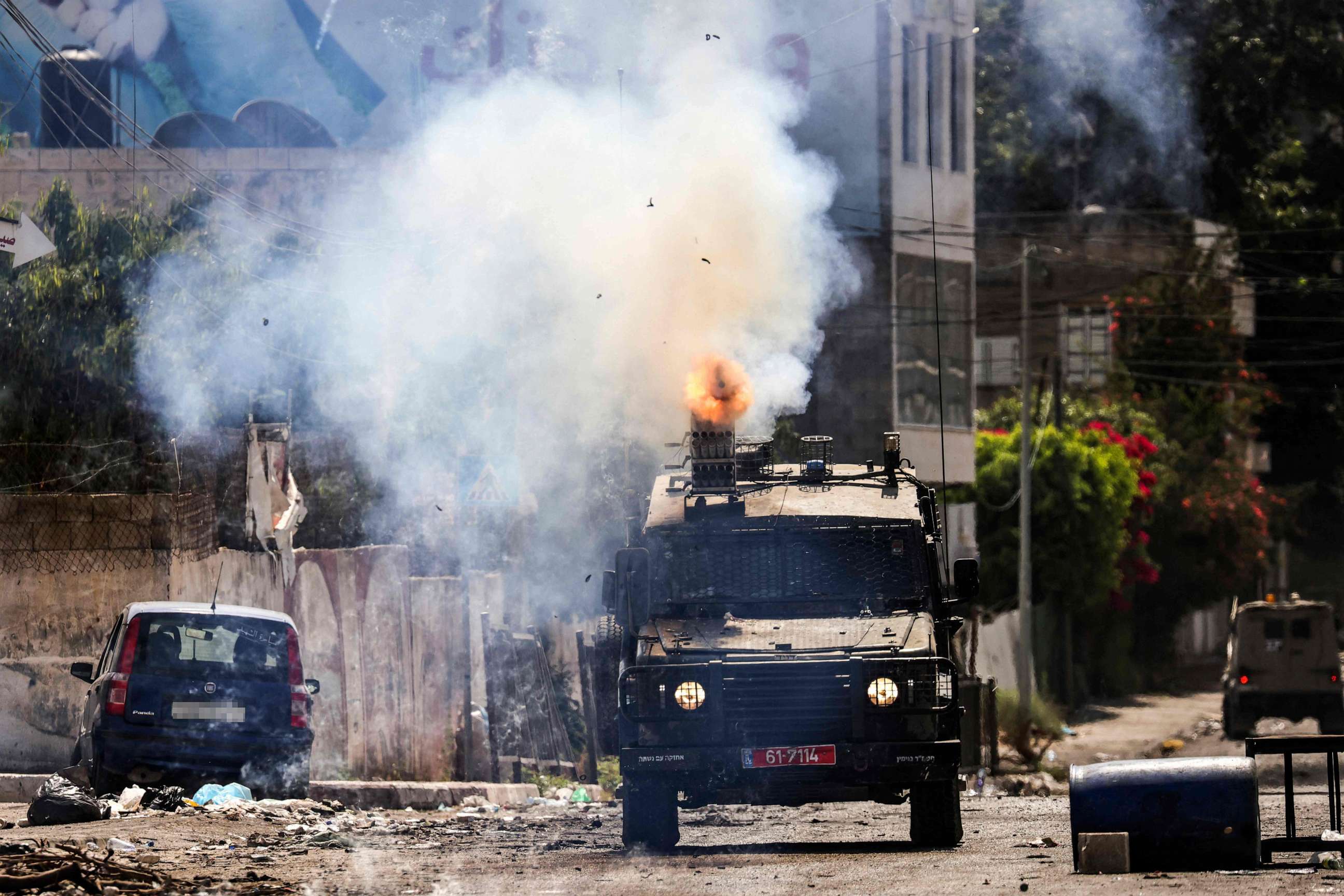 PHOTO: An Israeli armoured vehicle fires tear gas during an ongoing military operation in Jenin city in the occupied West Bank, July 4, 2023.