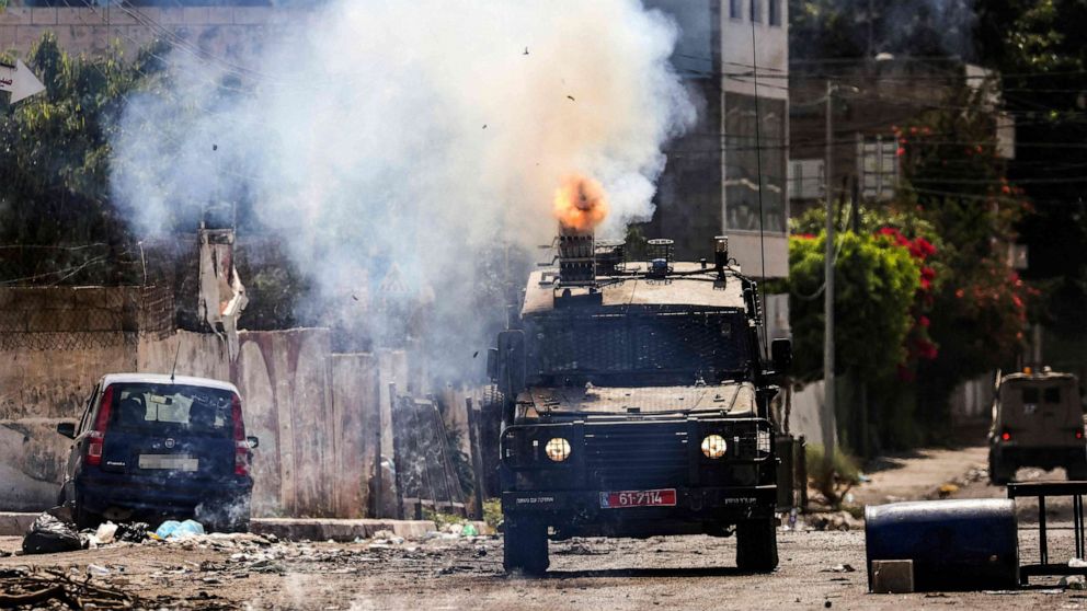 PHOTO: An Israeli armoured vehicle fires tear gas during an ongoing military operation in Jenin city in the occupied West Bank, July 4, 2023.