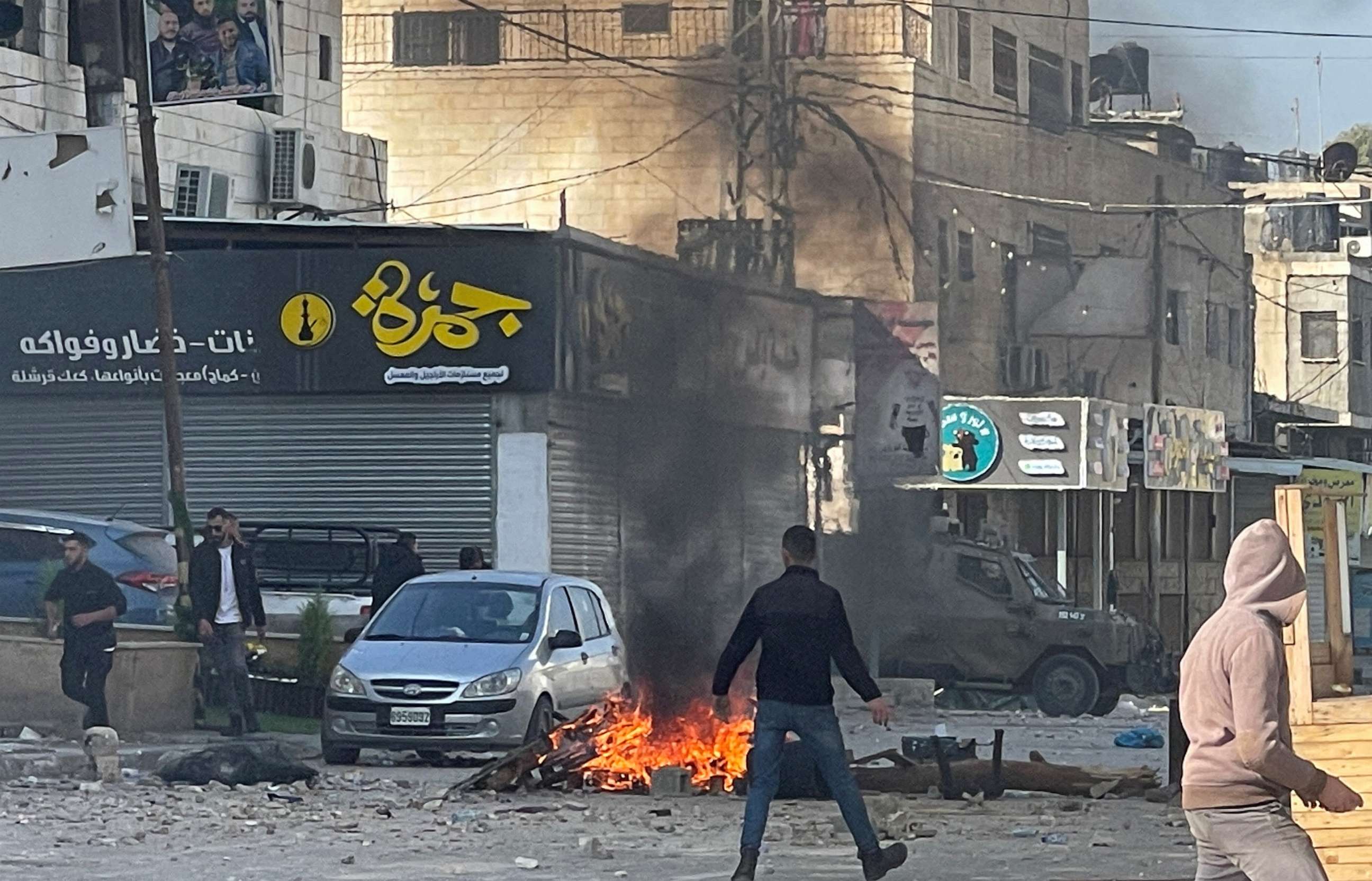 PHOTO: Palestinian stone-throwers gather amid clashes with Israeli troops during a raid in Jenin in the Israeli-occupied West Bank January 26, 2023.