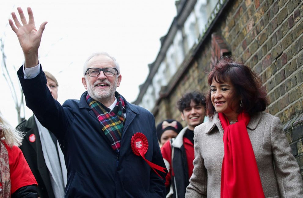 PHOTO: Britain's opposition Labour Party leader Jeremy Corbyn waves next to his wife Laura Alvarez as they walk to a polling station to vote in the general election in London, England, Dec. 12, 2019.