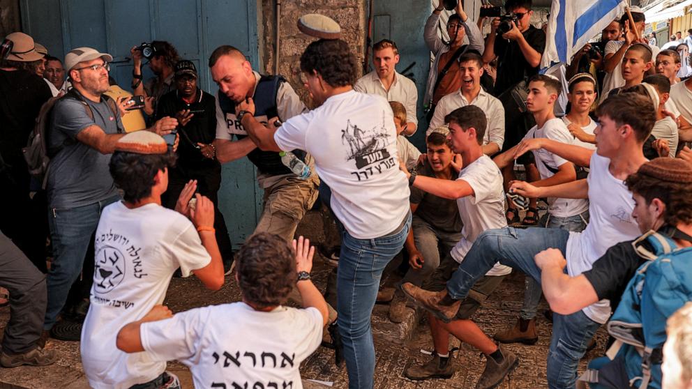 PHOTO: Israeli right-wing activists scuffle with a Palestinian freelance journalist Saif Kwasmi during a march commemorating Jerusalem Day, in the old city of Jerusalem on June 5, 2024.