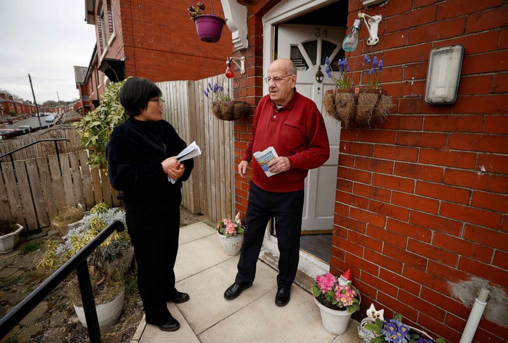 PHOTO: Jihyun Park talks with a local resident while out delivering leaflets after deciding to stand for election as a Conservative party candidate in the upcoming local elections in the Moorside Ward in Bury, Britain, March 22, 2021.