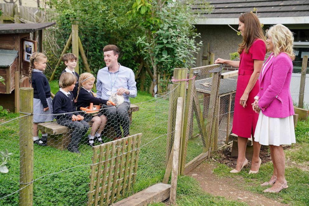 PHOTO: First lady Jill Biden and Britain's Catherine, Duchess of Cambridge, meet the school rabbit, Storm, during a visit to Connor Downs Academy, in Hayle, Cornwall, Britain, June 11, 2021.