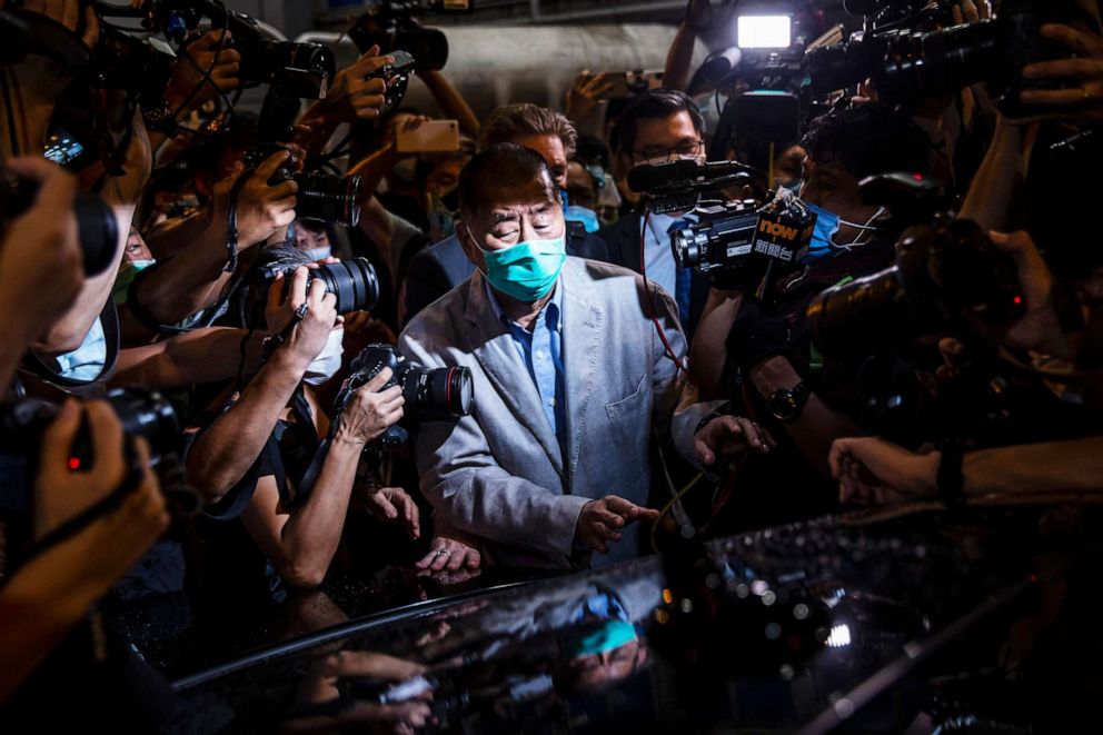 PHOTO: Jimmy Lai pushes through a media pack to get to a waiting vehicle after being released on bail from the Mong Kok police station in the early morning in Hong Kong, Aug. 12, 2020.