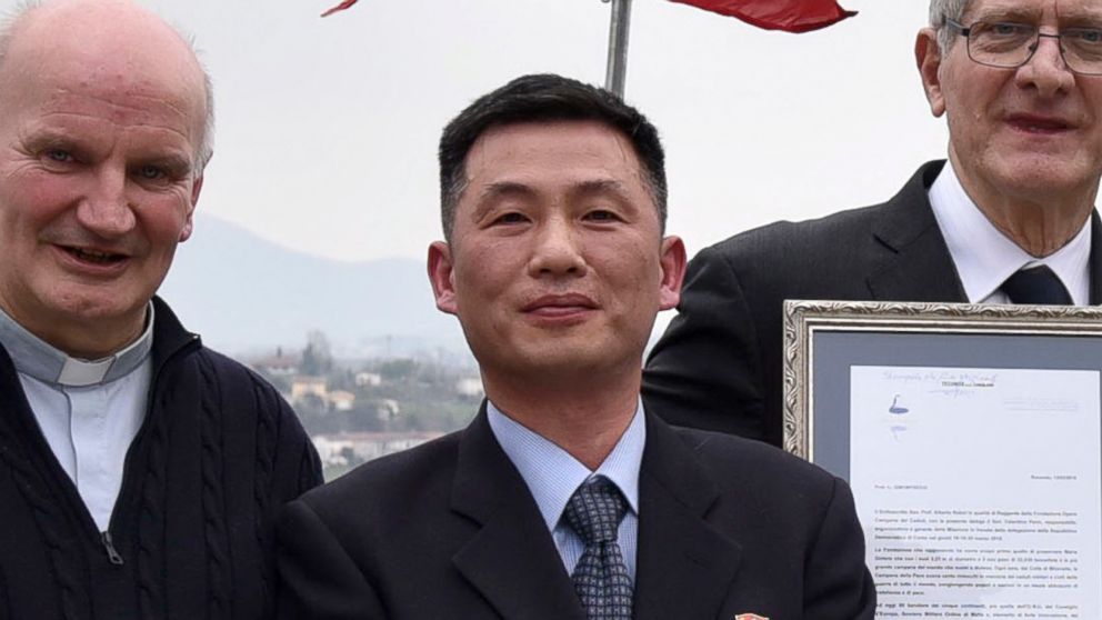 In this March 20, 2018 file photo the Parish of Farra di Soligo, shows North Korea's acting ambassador to Italy Jo Song Gil, center, holding a model of "Bell of Peace of Rovereto" during a cultural event  in San Pietro di Feletto, Italy.