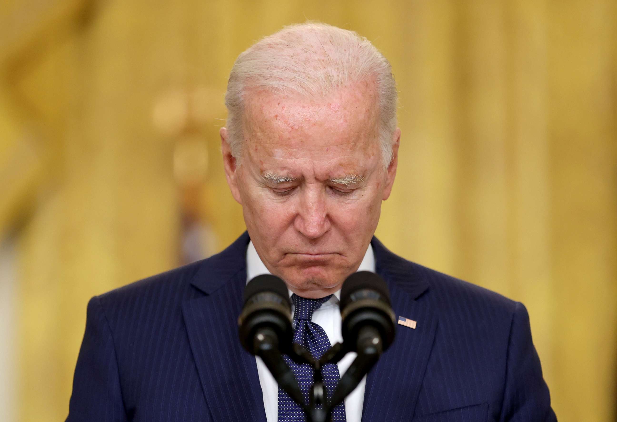 PHOTO: President Joe Biden observes a moment of silence for the dead as he delivers remarks about Afghanistan after a deadly bombing in Kabul, from the East Room of the White House in Washington, Aug. 26, 2021.