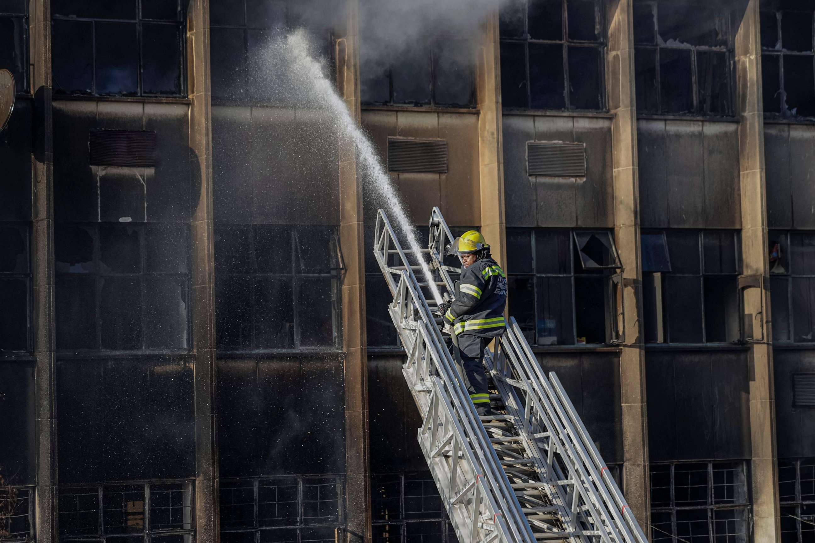 PHOTO: A firefighter extinguishes a fire at a five-story building in Johannesburg, South Africa, on Aug. 31, 2023.
