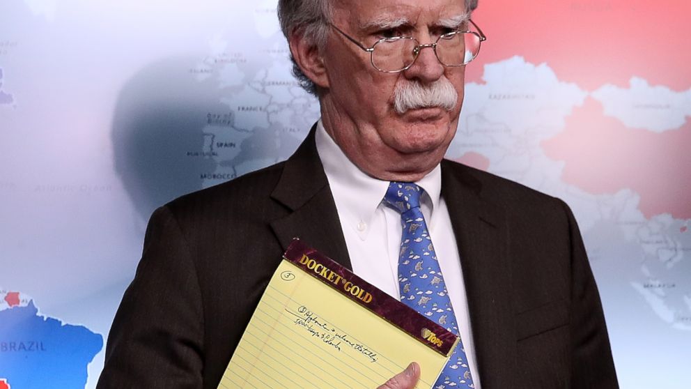 PHOTO: National Security Advisor John Bolton listens to questions from reporters during a press briefing at the White House, Jan. 28, 2019, while holding a legal pad with handwritten notes.