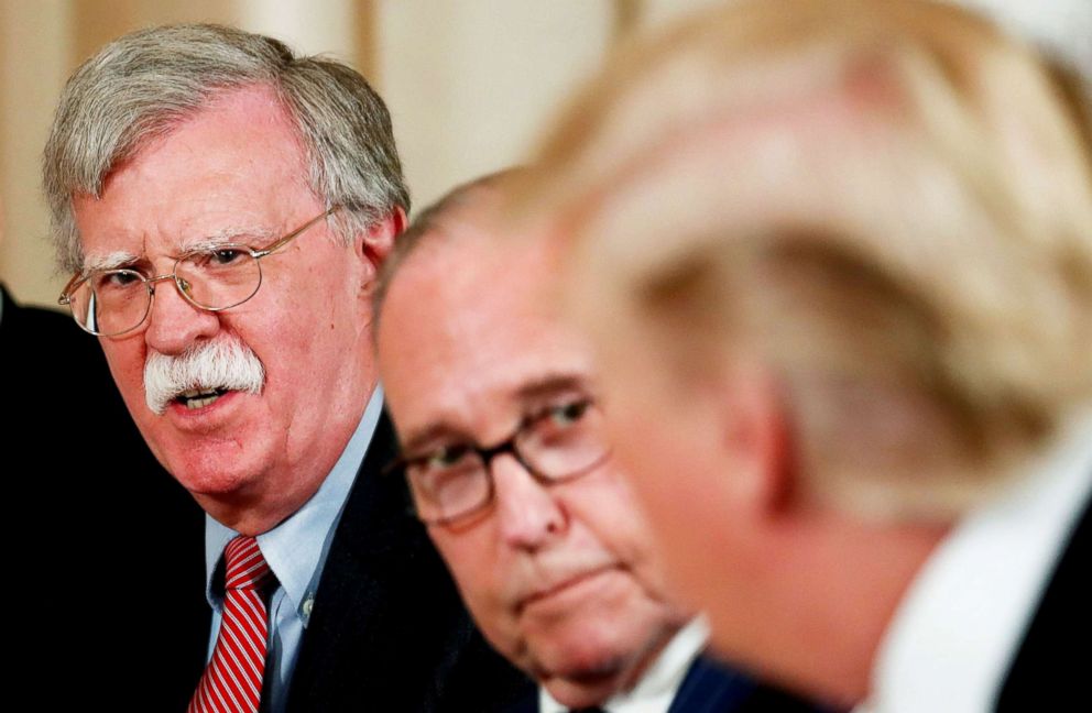 President Donald Trump, right, looks toward his national security adviser John Bolton, left, and economic adviser Larry Kudlow, center, during a working lunch with Japanese Prime Minister Shinzo Abe in Palm Beach, Fla., April 18, 2018.