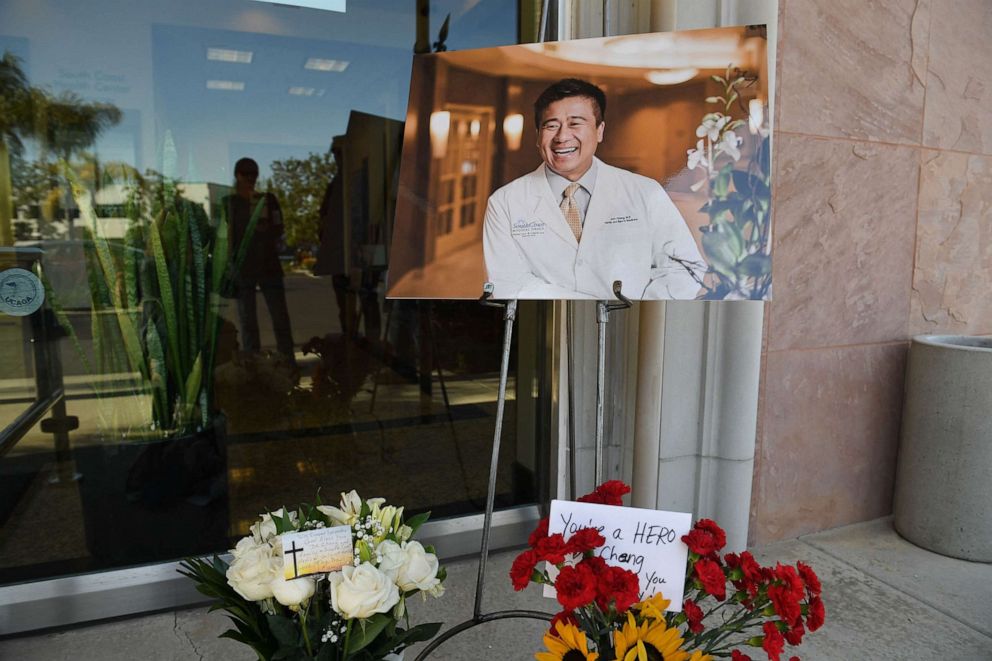 Flowers, cards and a photo of Dr. John Cheng are seen outside his office in Aliso Viejo, Calif., May 16, 2022, who was killed protecting others when a gunman opened fire at church services he was attending in nearby Laguna Woods, California on May 15.
